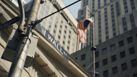 Wall Street Sign with American in Backgroundの写真素材