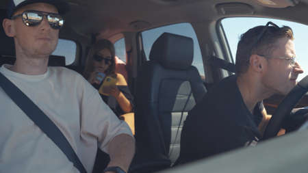 Group of happy friends on a carの写真素材