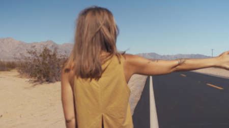 Girl Hitchhiking in Arizona, USAの写真素材