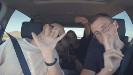 Group of happy friends on a carの写真素材