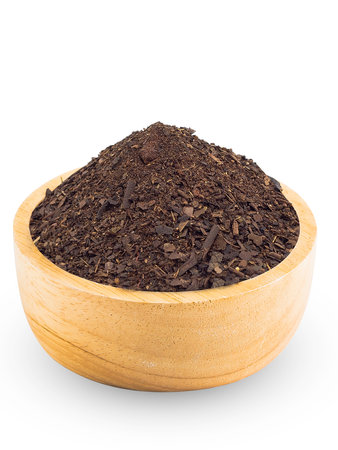 Dry Thai Tea leaves in the wood cup with white background isolate.の写真素材