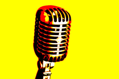 Vintage shiny microphone on a yellow backgroundの写真素材