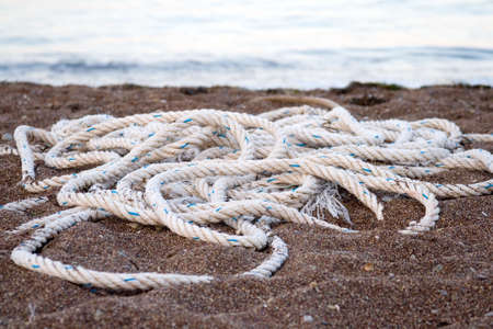 Entangled hawser lying on the beach