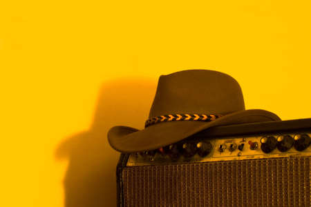 A cowboy hat and a vintage vacuum tube amplifierの写真素材