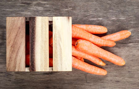 raw carrots in wooden box.の写真素材
