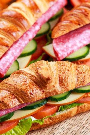 Fresh croissant with salami, chesse and vegetablesの写真素材