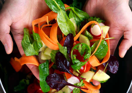 Fresh Close up Vegetable, Vegan salad in man hand. healthy food.の写真素材