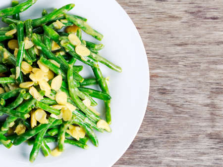 Green beans roasted in garlic and flaked almond.