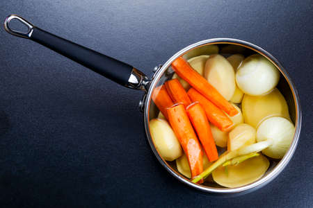 preparing vegetable stock bouillon in a pot.の写真素材