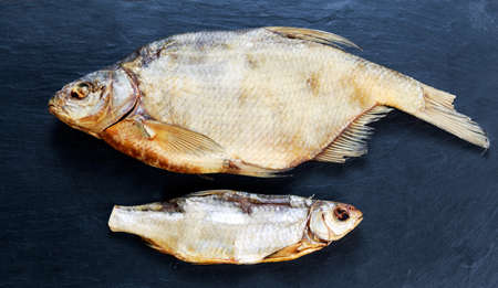 Salted Dry fish vobla on blue stone background.