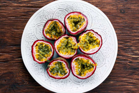 Ripe passion fruit on a wooden background.の写真素材