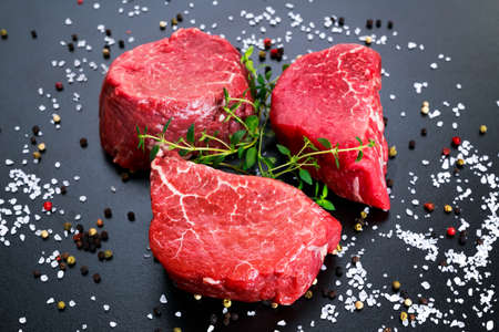 Fresh Raw Beef Filet Mignon, with salt, peppercorns and thyme. Ready to cookの写真素材