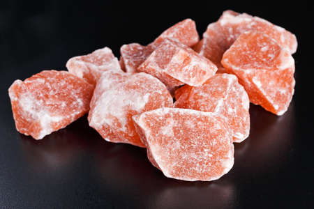 Himalayan pink crystal salt on dark background.の写真素材