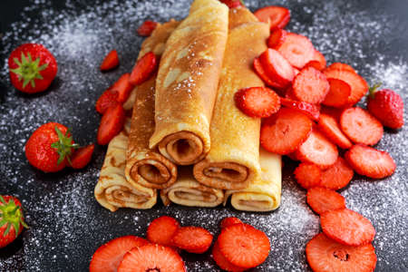 Sweet Rolled Pancakes powdered sugar with and strawberryの写真素材