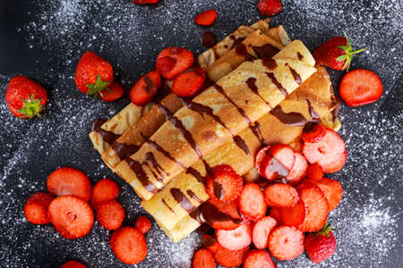 Sweet Rolled Pancakes with nutella and strawberry.の写真素材