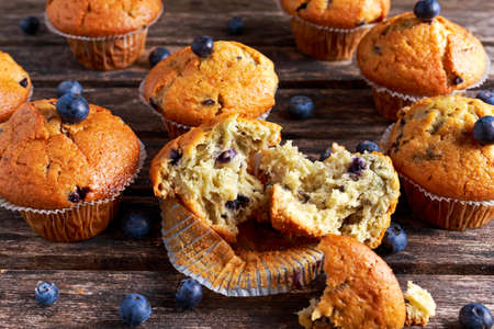 Homemade Blueberry Muffins with fresh berries on wooden table.の写真素材