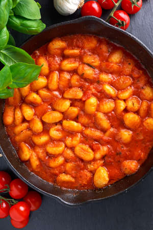 Homemade Italian Gnocchi with marinara sauce in iron pan.の写真素材