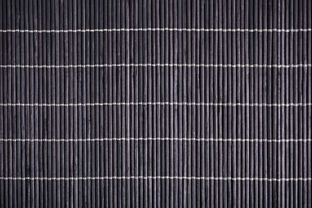 Close up dark bamboo mat background, texture.の写真素材