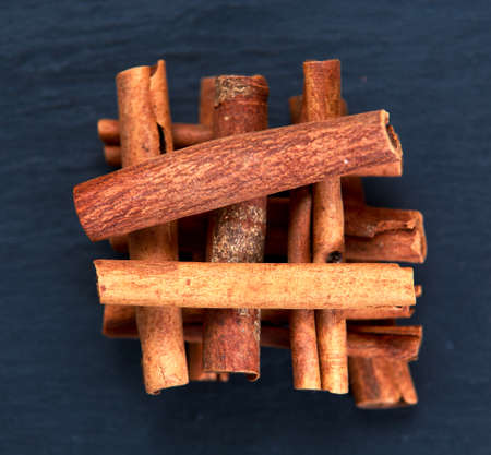 Cinnamon sticks and anice on wooden table. selected focus.