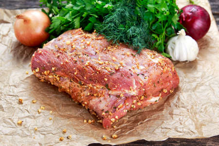 Fresh pork carbonade, meat marinated and prepared for roast with garlic, herbs.