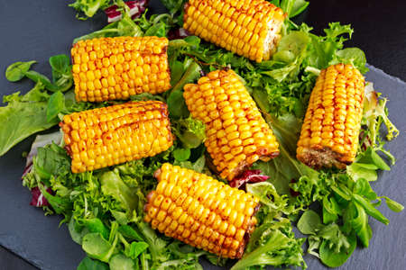 Delicious oven cooked Corn with feta cheese, paprika, lime, vegetablesの写真素材