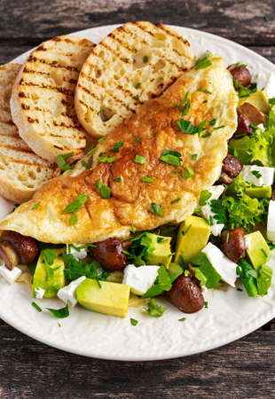 Mushroom, Feta Cheese egg Omelette witch Avocado, vegetables, lettuce, herbs and grilled bread