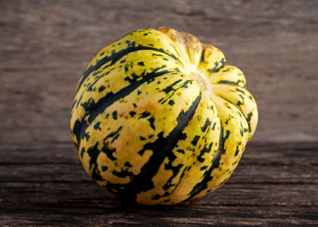 raw coloured autumn Pumpkin on wooden background.の写真素材