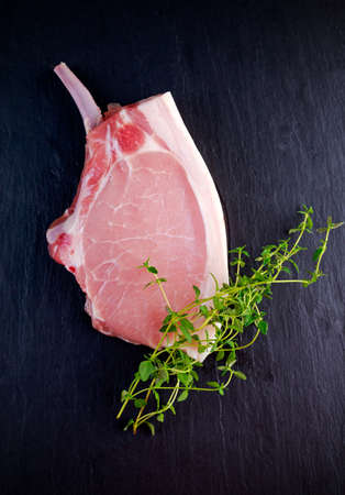 Top view Raw pork cutlet close up. on stone background.の写真素材
