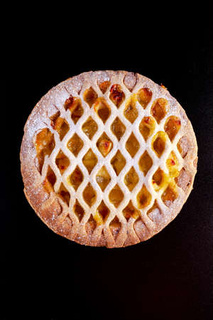 Home baked Lattice apple pie on black background.の写真素材