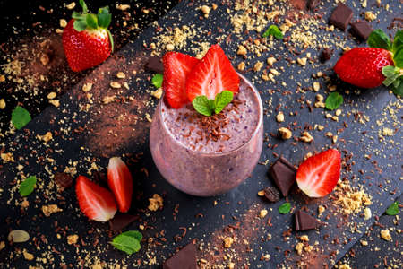 Healthy Breakfast Chocolate, berry and oats Smoothie decorated with strawberry.の写真素材
