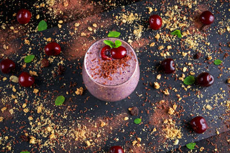 Healthy Breakfast Chocolate, berry and oats Smoothie decorated with cherry.の写真素材