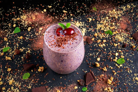 Healthy Breakfast Chocolate, berry and oats Smoothie decorated with cherry.の写真素材