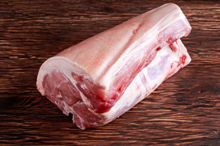 Fresh Raw French whole pork t-bone on wooden board.の写真素材