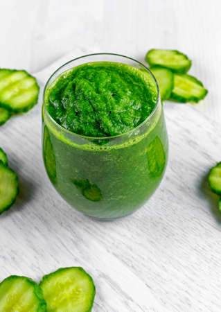 Fresh Green smoothie with kale, cucumber, lime, apple, parsley on white board.の写真素材
