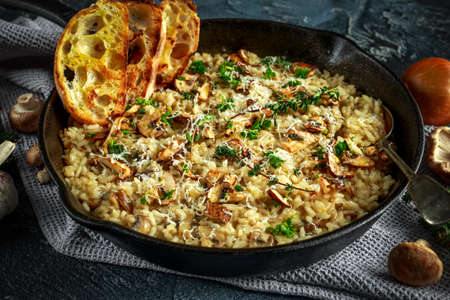 Mushroom Risotto in iron pan with herbs and parmesan cheeseの写真素材
