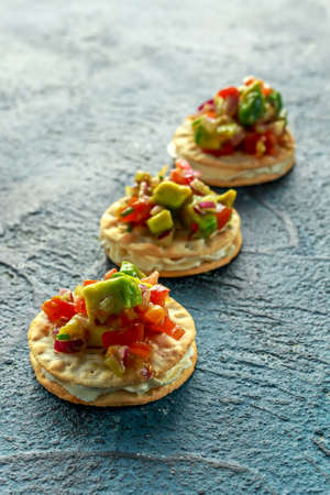 Salsa canape cracker appetizers with soft cheese.の写真素材