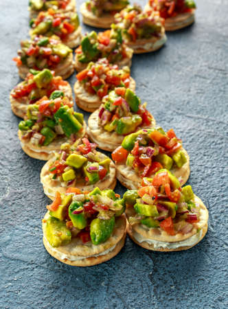 Salsa canape cracker appetizers with soft cheeseの写真素材