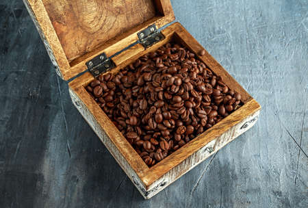 Coffe beans in open old wooden white chestの写真素材