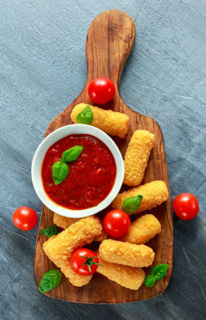 Breaded mozzarella cheese sticks with tomato basil sauce.の写真素材