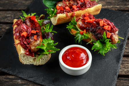 Cumberland sausage hot dogs with caramelized onion, roasted red peppersの写真素材