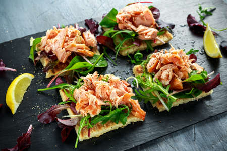 Smoked salmon flakes on salad bed and irish potato slims snacks, appetizers