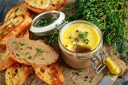 Home made chicken liver pate with thyme and ciabatta bread in jarの写真素材