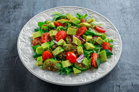 Quinoa tabbouleh salad with avocado, tomatoes, cucumber, green onion. Concept healthy food.の写真素材