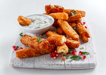 Crispy Halloumi cheese sticks Fries with yogurt for dipping and pomegranate seeds.の写真素材