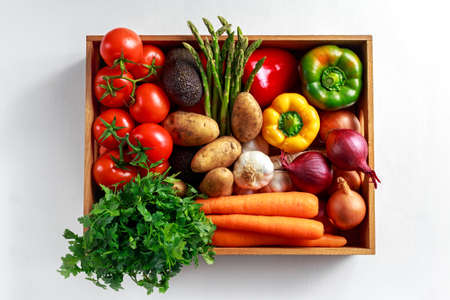 Fresh Vegetables in wooden box on white wooden backgroundの写真素材