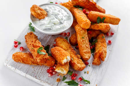Crispy Halloumi cheese sticks Fries with yogurt for dipping and pomegranate seeds.の写真素材