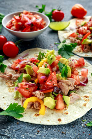 Tuna Tortilla with avocado, fresh salsa, limes, greens, parsley, tomatoes, red yellow pepper....