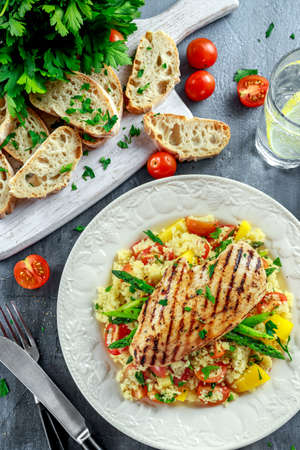 couscous salad with grilled chicken and asparagus on white plate. healthy foodの写真素材
