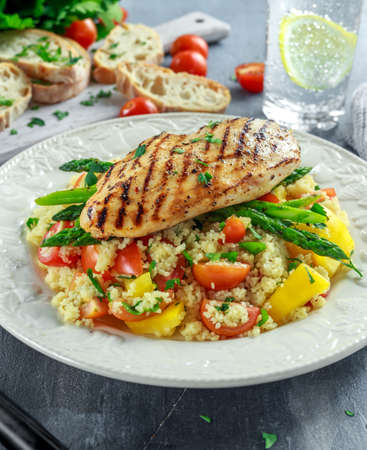 couscous salad with grilled chicken and asparagus on white plate. healthy foodの写真素材