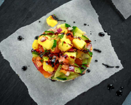 Tuna sushi stacks with mango, cucumber, tomatoes salsa served with balsamic vinegar, nigela ans sesame seedsの写真素材